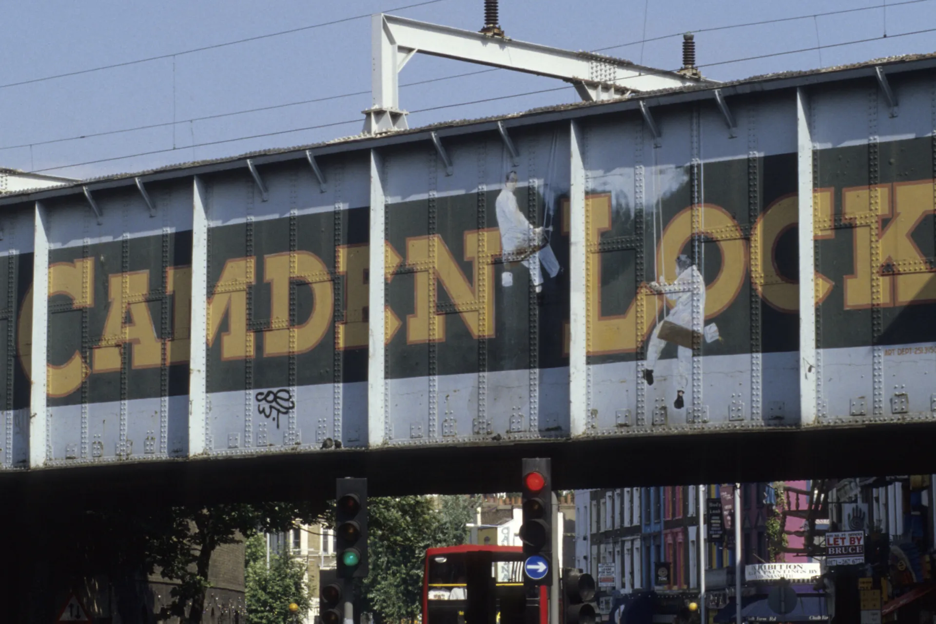 Painted sign reading "Camden Lock" on a rail bridge
