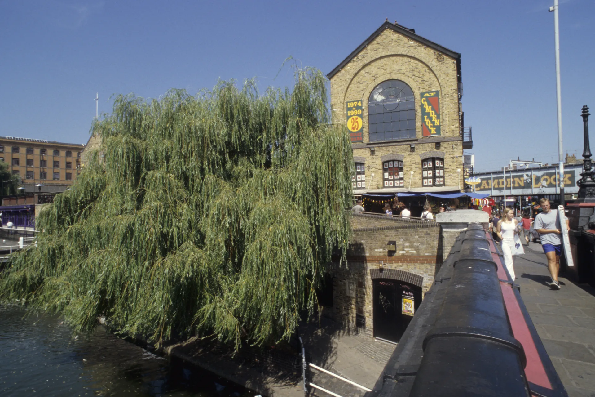People walking over the canal at Camden Lock market