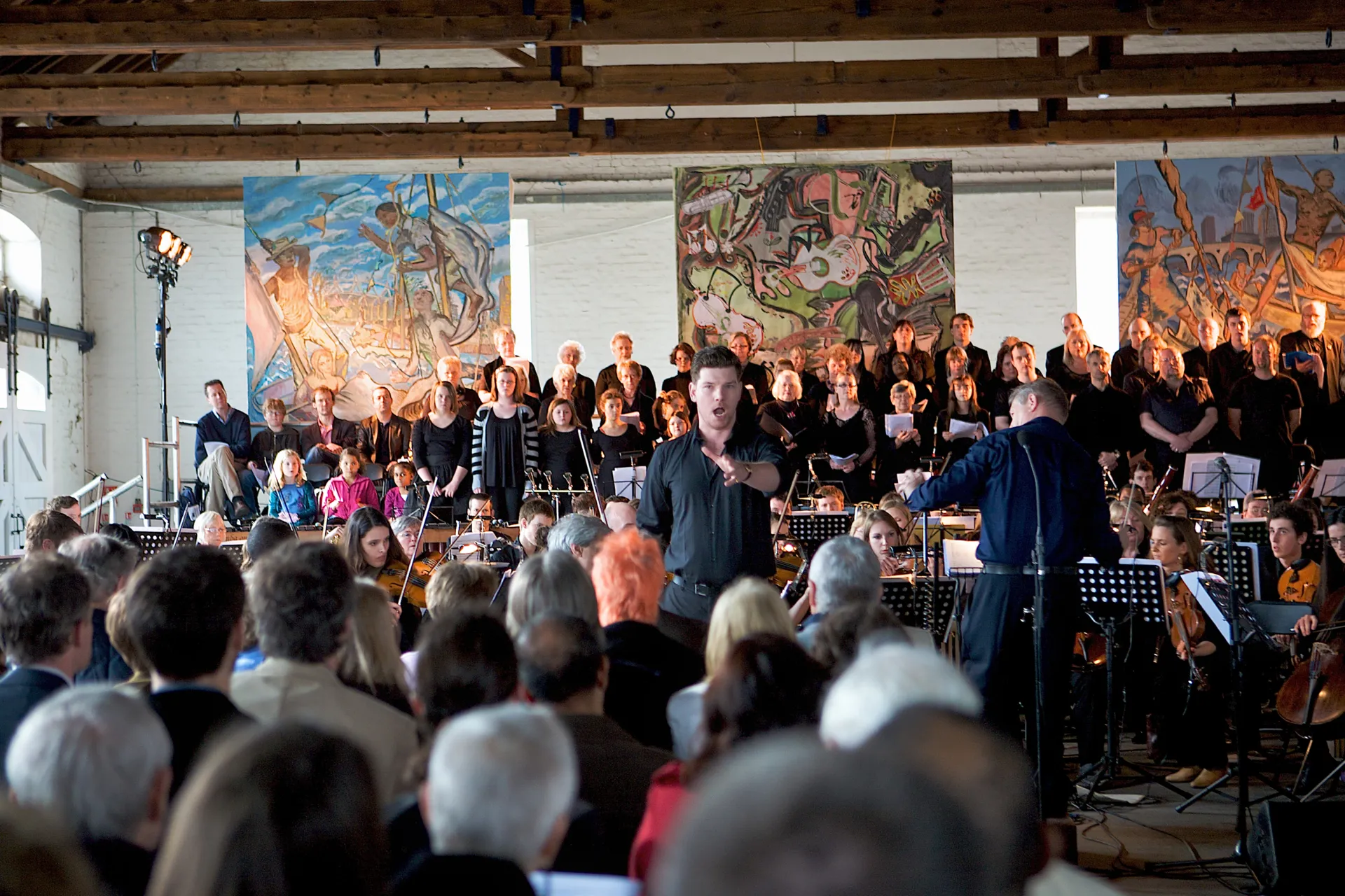 Opera singer surrounded by an orchestra and an audience