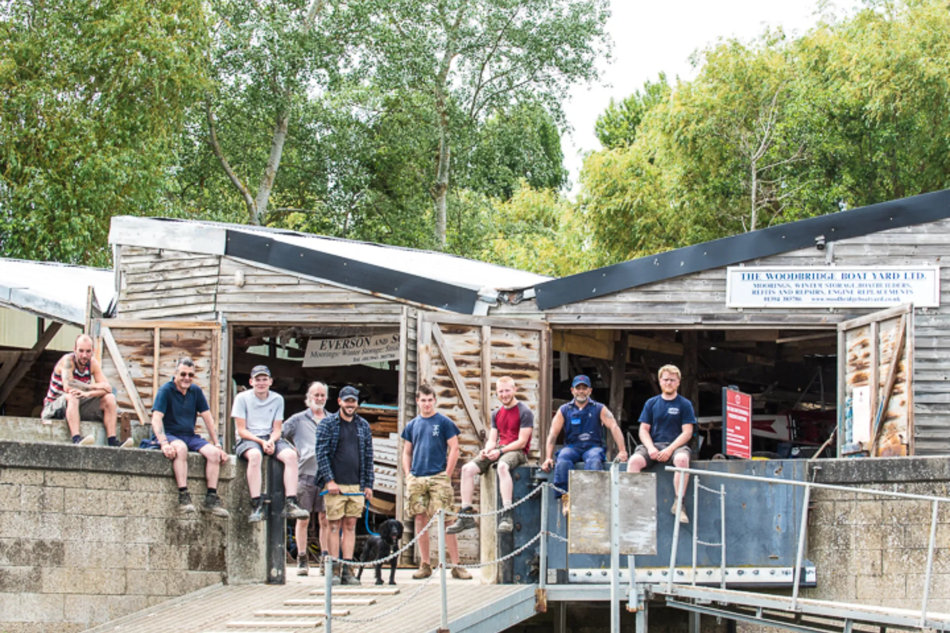 People seating in front of wooden  sheds
