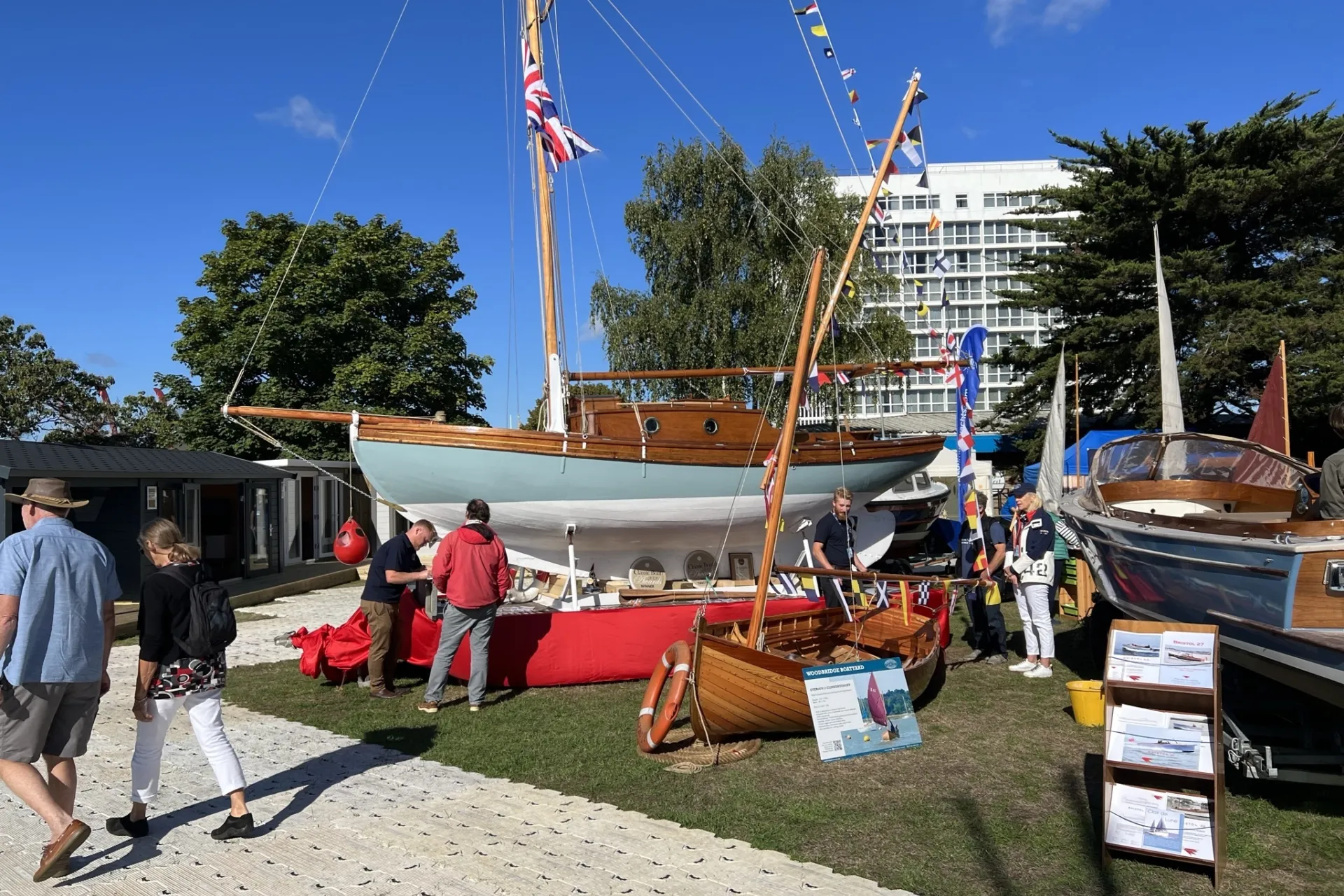 People walking in front of a boat