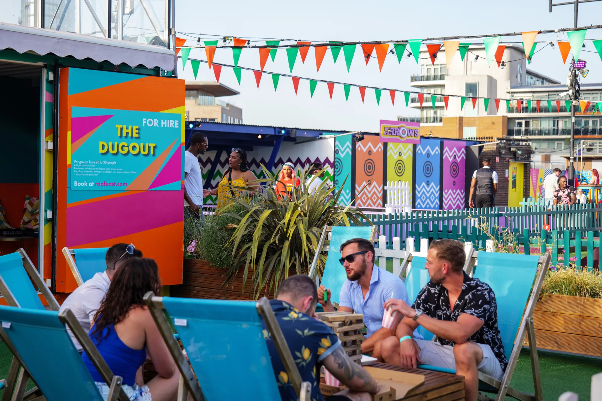 People sitting on blue deckchairs